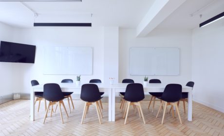 picture of room with empty chairs round a table to suggest 70:20:10 collaborative work