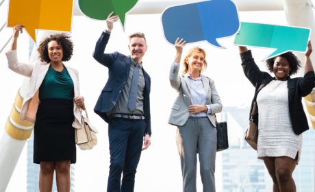 pic of people holding up empty speech bubbles to represent modern performance management